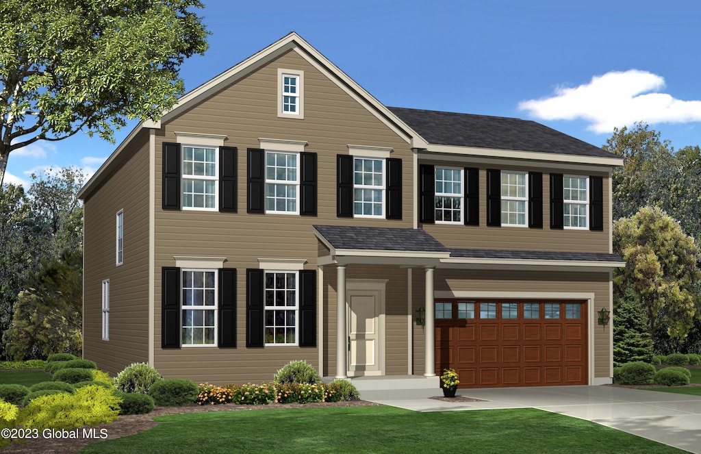 view of front of house featuring a front lawn and a garage