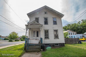 64 Spring St, Gloversville, NY 12078 - view of front of home featuring a front lawn
