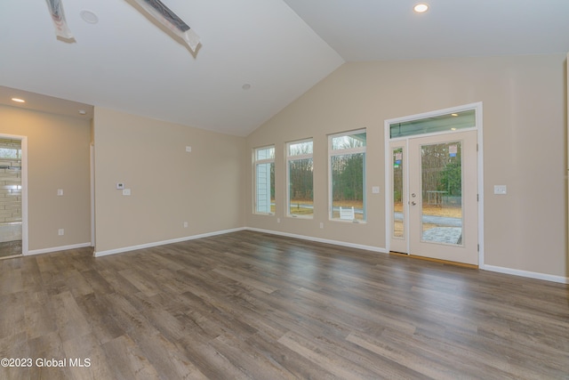 unfurnished living room featuring wood-type flooring and vaulted ceiling