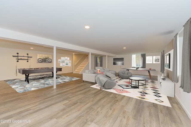 living room featuring pool table and light hardwood / wood-style flooring