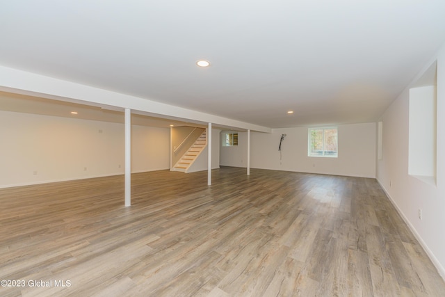 basement with light hardwood / wood-style floors