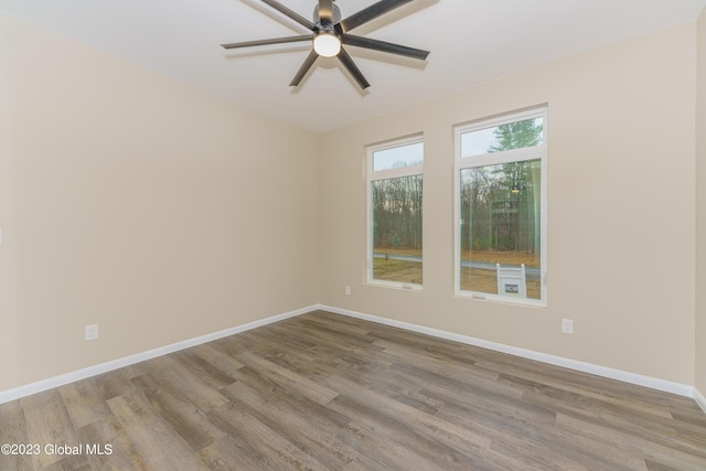 spare room with ceiling fan and light wood-type flooring