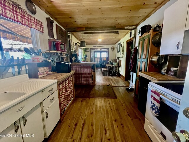 kitchen featuring hanging light fixtures, hardwood / wood-style floors, white cabinetry, wood ceiling, and white electric range oven