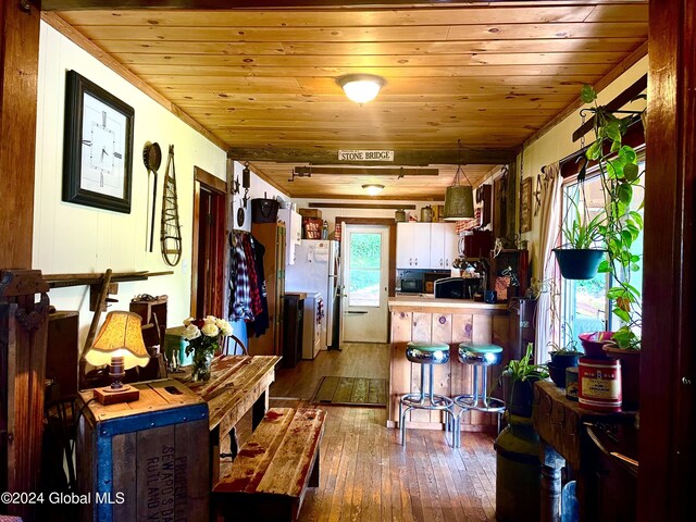 dining room featuring wooden ceiling and hardwood / wood-style flooring