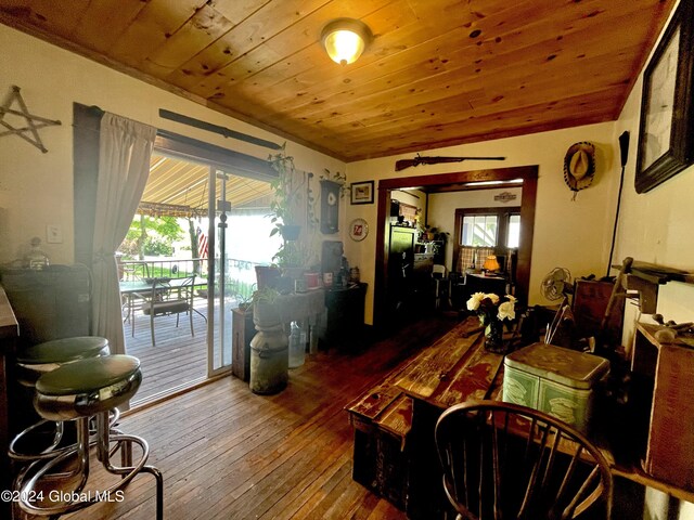 living room with hardwood / wood-style floors, a wealth of natural light, and wood ceiling