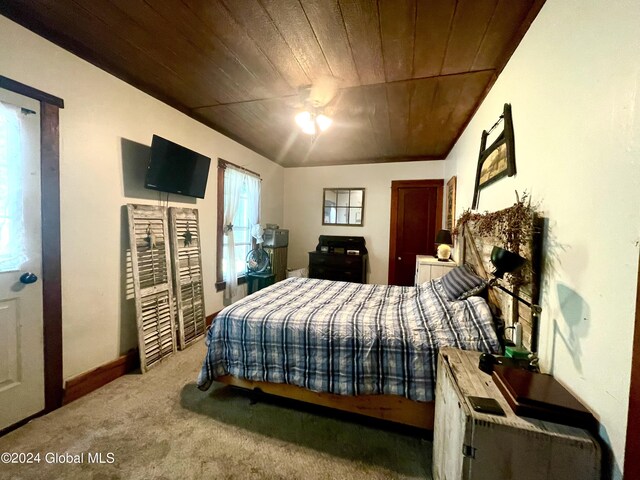 bedroom with wood ceiling and carpet floors