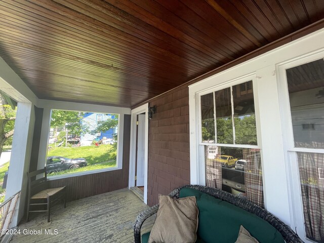 sunroom with plenty of natural light and wood ceiling