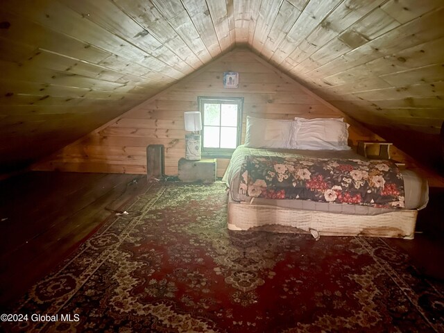 unfurnished bedroom with wood-type flooring, wood walls, wood ceiling, and vaulted ceiling