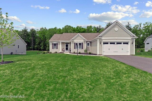 ranch-style house with driveway, a garage, and a front yard