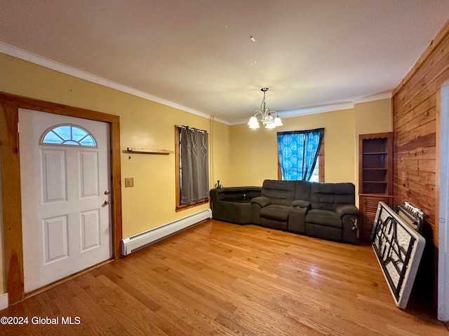 living room featuring wood walls, light hardwood / wood-style flooring, a baseboard radiator, and a chandelier