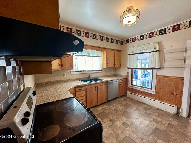 kitchen featuring sink, a baseboard radiator, light tile flooring, and stainless steel appliances