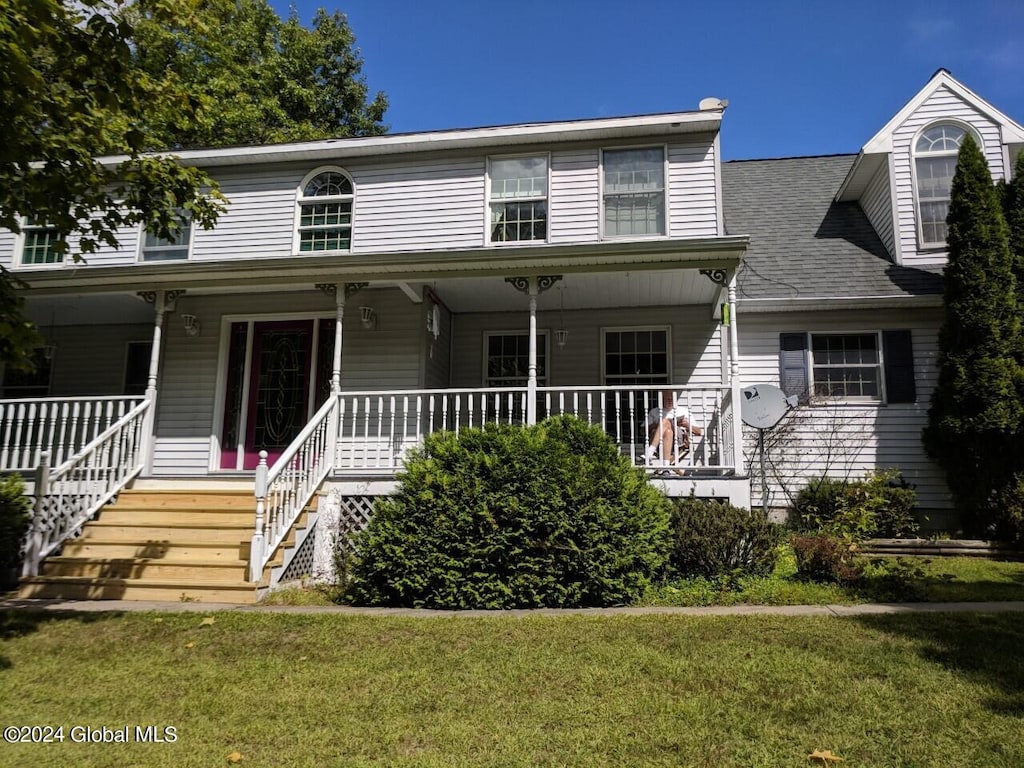 view of front facade with a front yard and covered porch