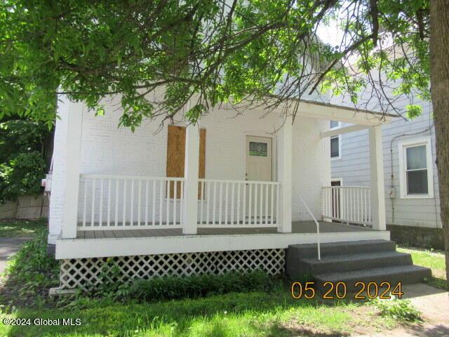 back of property with a porch