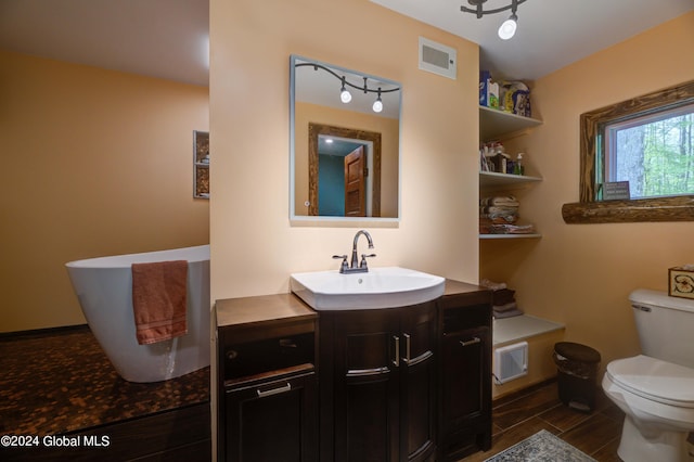 bathroom with tile floors, vanity, and toilet