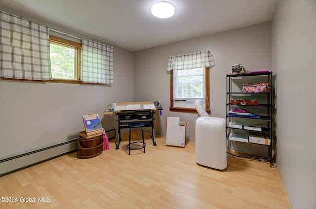 office featuring a baseboard heating unit and hardwood / wood-style floors