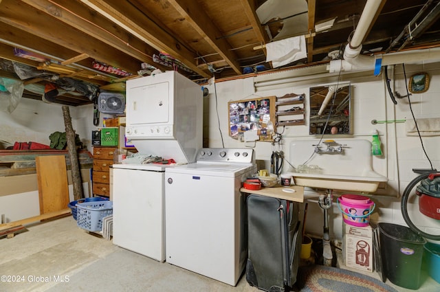 laundry area featuring sink and stacked washer and clothes dryer