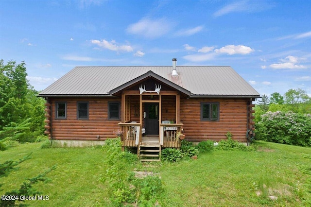 2216 State Route 28n, Minerva, NY 12851 - log cabin with log exterior, a front lawn, a metal roof, and covered porch