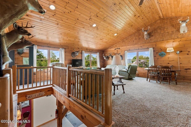 interior space with vaulted ceiling, wood walls, and wood ceiling