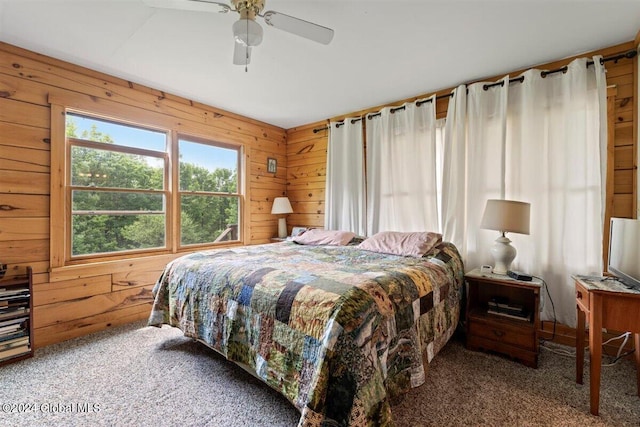 carpeted bedroom with wooden walls and ceiling fan