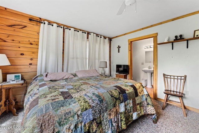 bedroom with ceiling fan, carpet floors, crown molding, sink, and connected bathroom