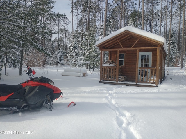 snow covered structure with an outdoor structure