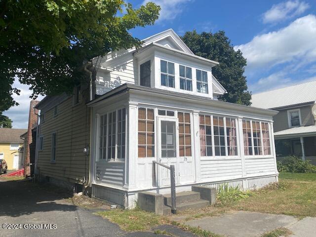 view of side of home featuring a sunroom