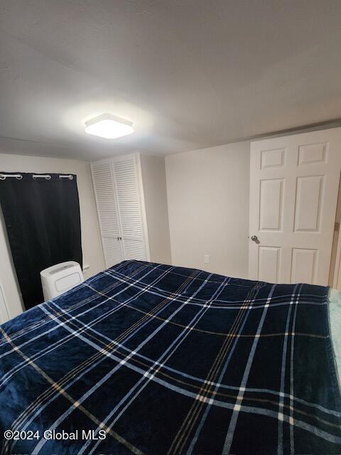 unfurnished bedroom with a closet