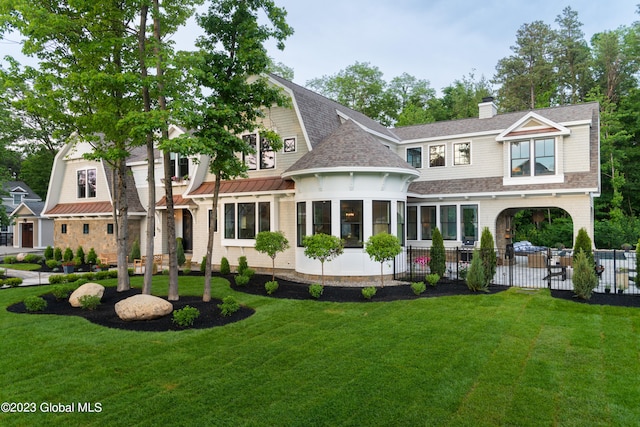 back of house with a yard and a sunroom