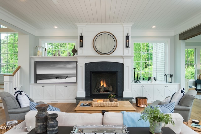 living room featuring a wealth of natural light, hardwood / wood-style floors, crown molding, and wooden ceiling