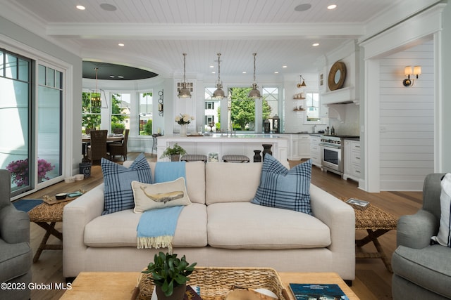 living room with hardwood / wood-style floors, beam ceiling, wooden ceiling, and a wealth of natural light