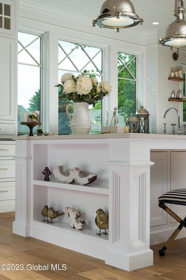 bar featuring wood ceiling, sink, light wood-type flooring, and white cabinets