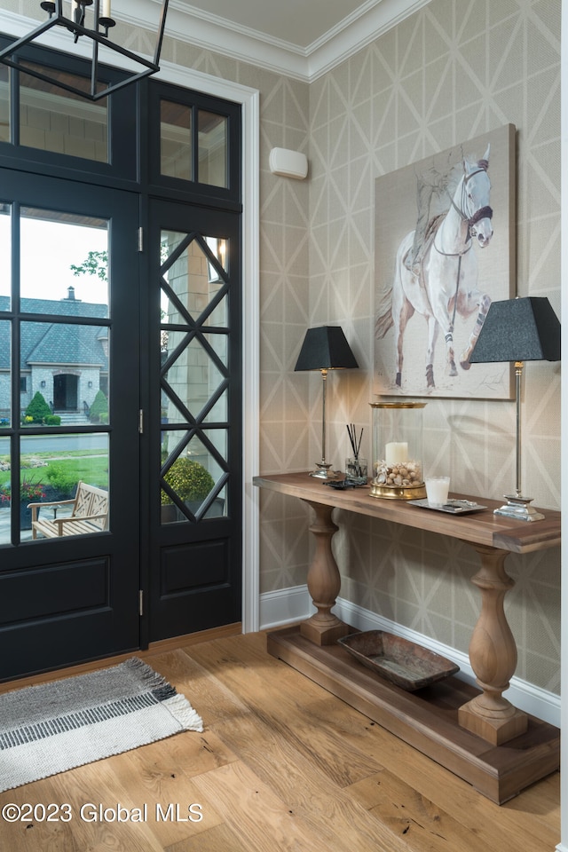 foyer entrance featuring crown molding and wood-type flooring