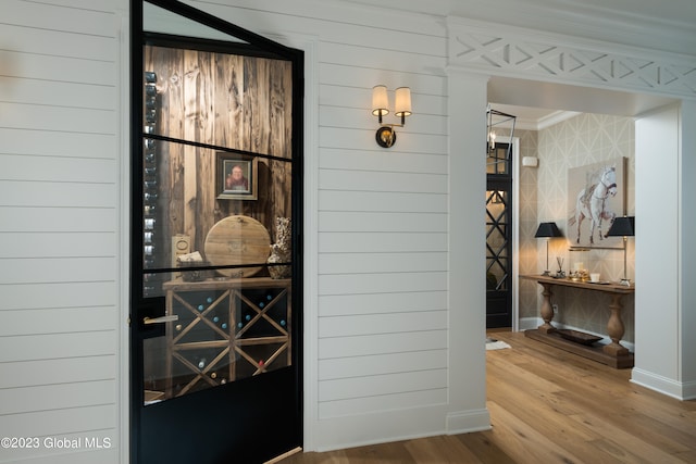 hallway with crown molding and wood-type flooring