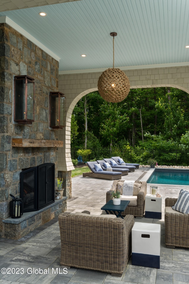 view of patio featuring an outdoor living space with a fireplace