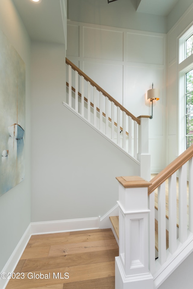 stairs with hardwood / wood-style flooring