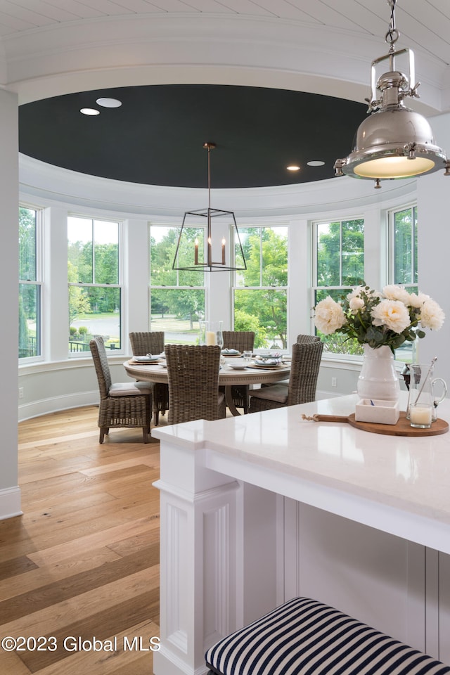 dining area with a healthy amount of sunlight, wooden ceiling, and light wood-type flooring