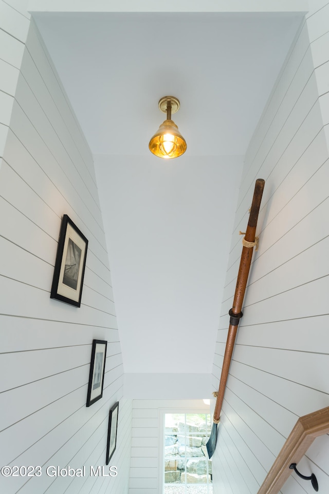 staircase with wooden walls