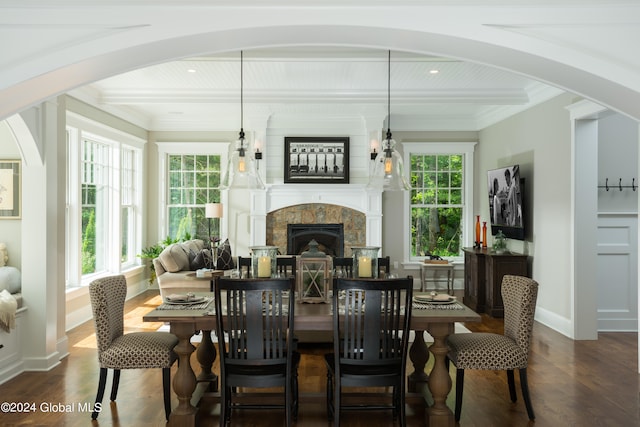 dining space with dark hardwood / wood-style floors, beamed ceiling, and a wealth of natural light