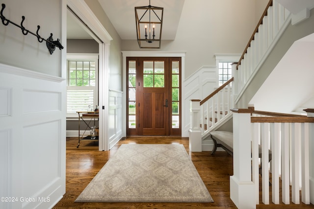 entrance foyer with a chandelier and dark hardwood / wood-style floors