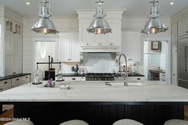 kitchen with a large island, a healthy amount of sunlight, and decorative light fixtures