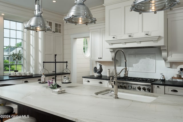 kitchen featuring white cabinetry, pendant lighting, and a wealth of natural light