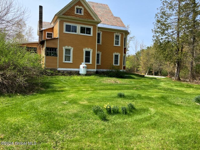 back of property with a lawn