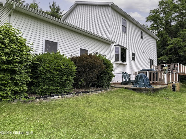 rear view of property featuring a yard