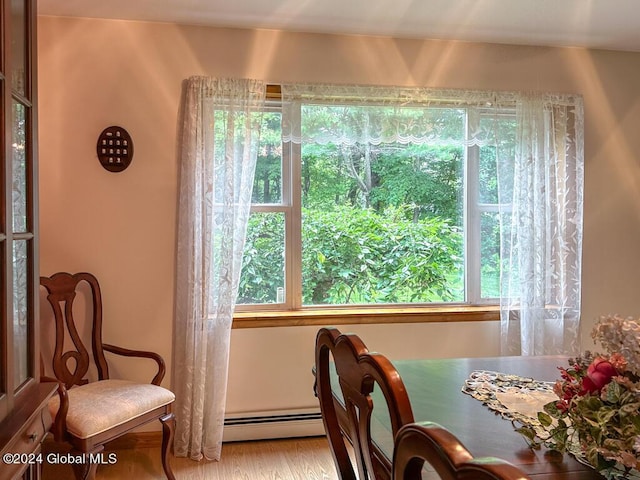 dining room featuring light hardwood / wood-style flooring and a baseboard heating unit