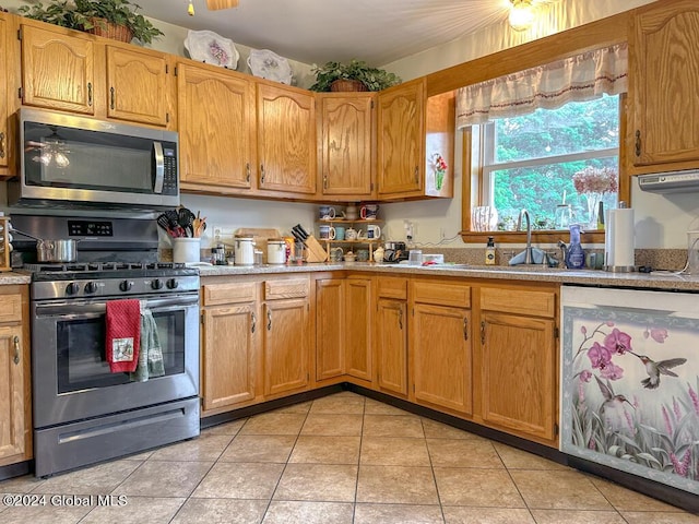 kitchen with sink, light tile patterned flooring, and stainless steel appliances