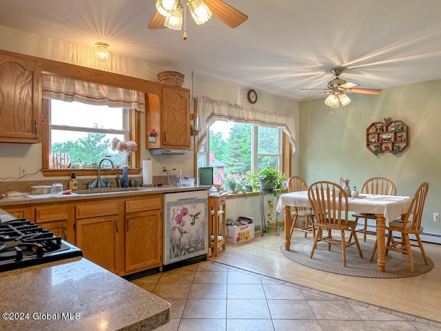 kitchen with stainless steel dishwasher, ceiling fan, light tile patterned flooring, and sink