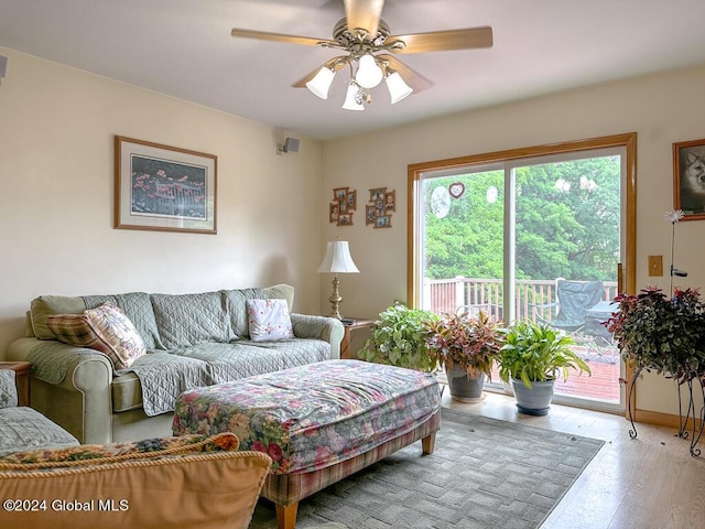 living room with light hardwood / wood-style flooring and ceiling fan