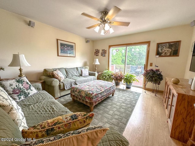 living room featuring light hardwood / wood-style flooring and ceiling fan