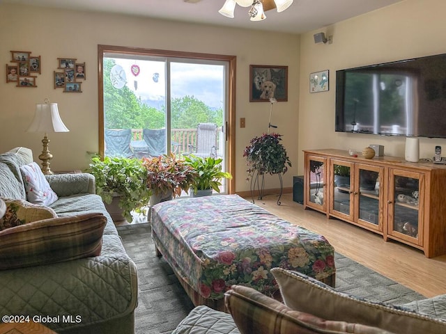 living room featuring hardwood / wood-style floors and ceiling fan