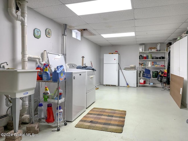 clothes washing area with cabinets and independent washer and dryer